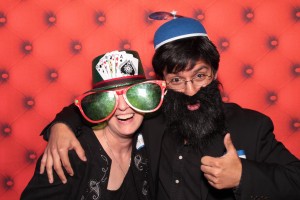 Couple-Beard-Glasses-Beanie-Red-Background-Service-Happy